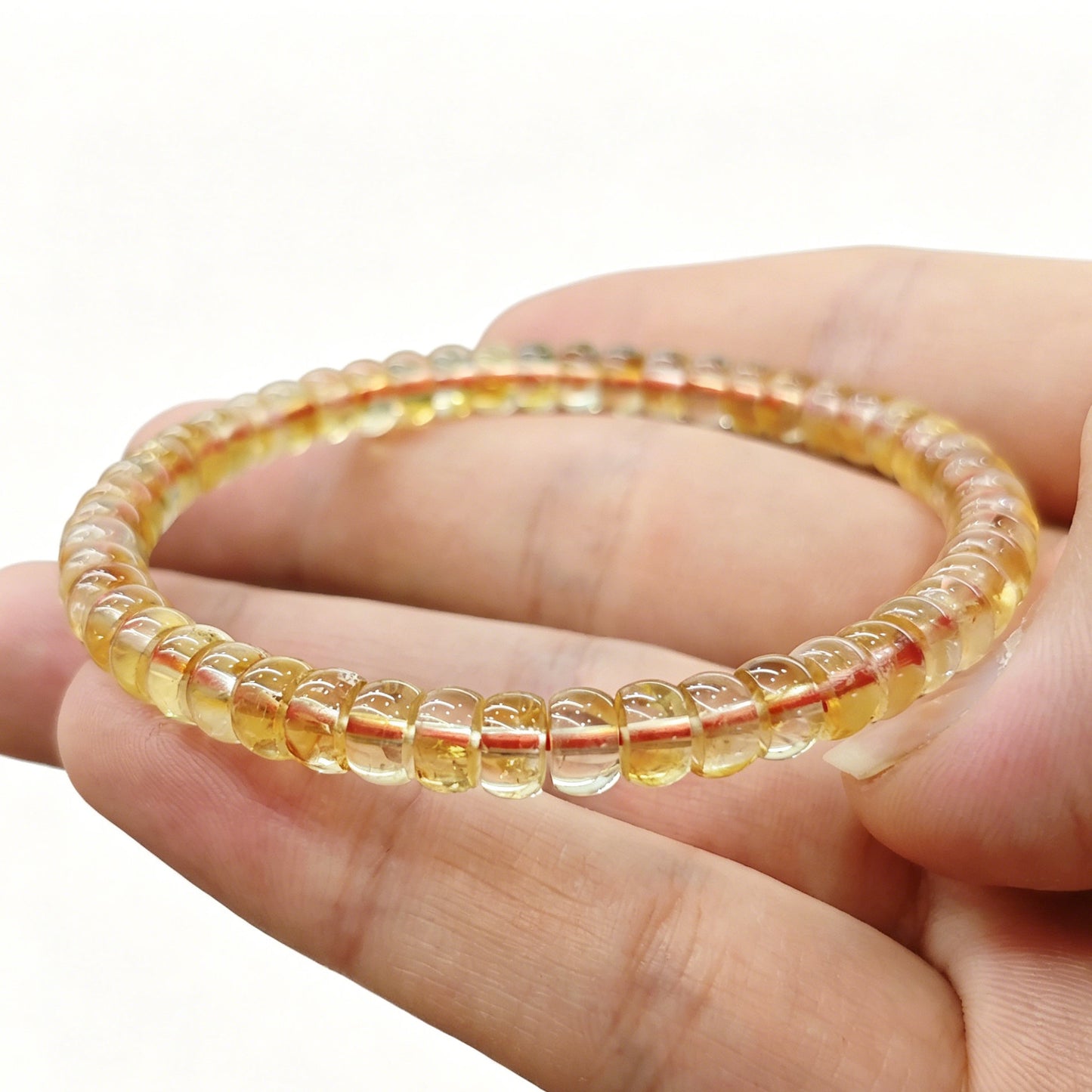 Citrine tablet bracelet resting on palm—highlighting delicate size, warm hue, and natural clarity