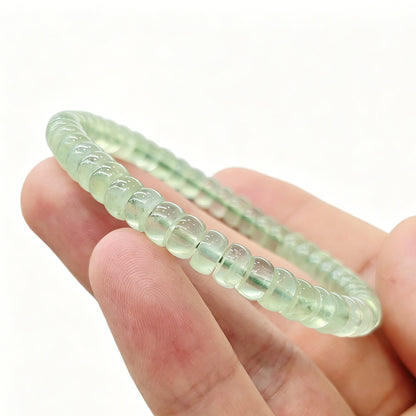 Prehnite tablet bracelet resting on palm—highlighting delicate size, soft green hue, and natural clarity