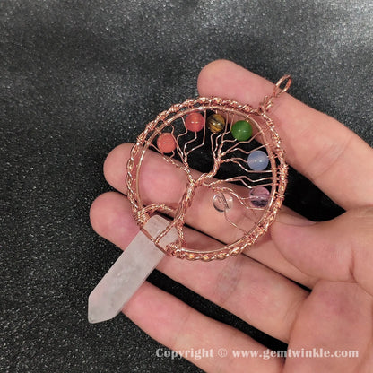 Handheld view of 8cm tree of life snow quartz point pendant showing natural dense cloud inclusions
