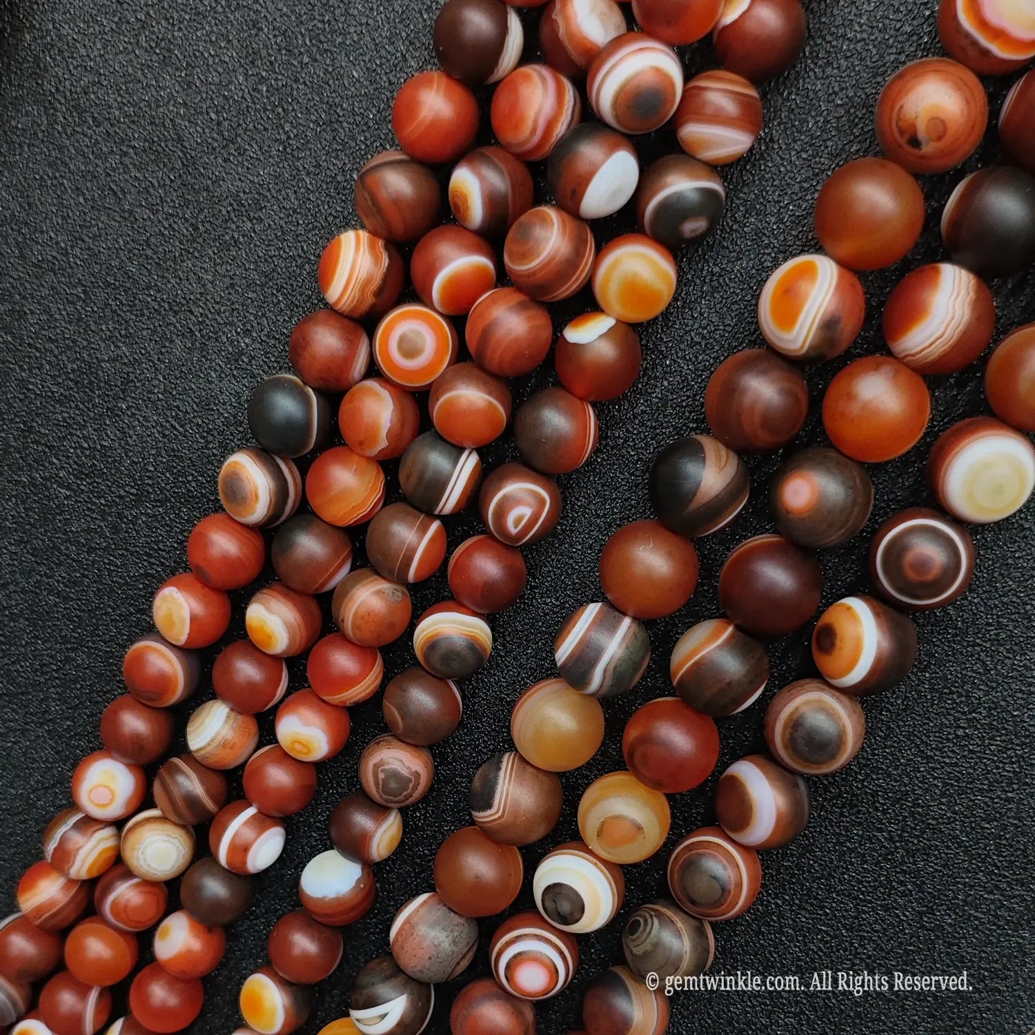 Bulk assortment of red dzi agate crystal beads for independent jewelry designers