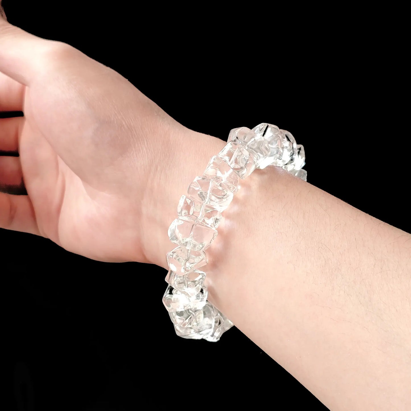 Men’s natural crystal bracelet worn on wrist: chunky 16–20mm beads, flexible fit, minimalist spiritual accessory for daily wear or meditation sessions