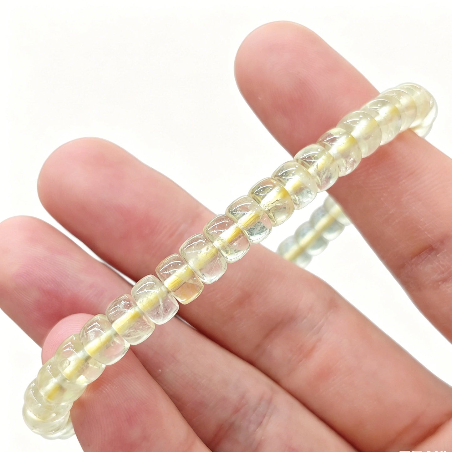Mini lemon citrine tablet bracelet gently flexed to demonstrate elasticity and uniform bead alignment