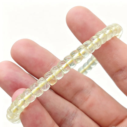 Mini lemon citrine tablet bracelet gently flexed to demonstrate elasticity and uniform bead alignment