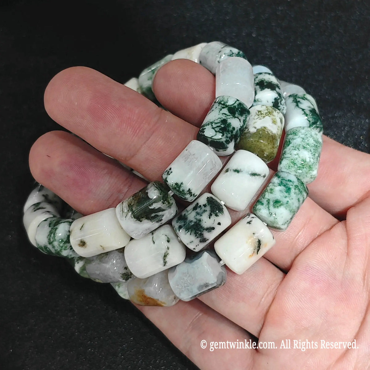 Moss Agate Barrel Bead Strands Close Up on Hand