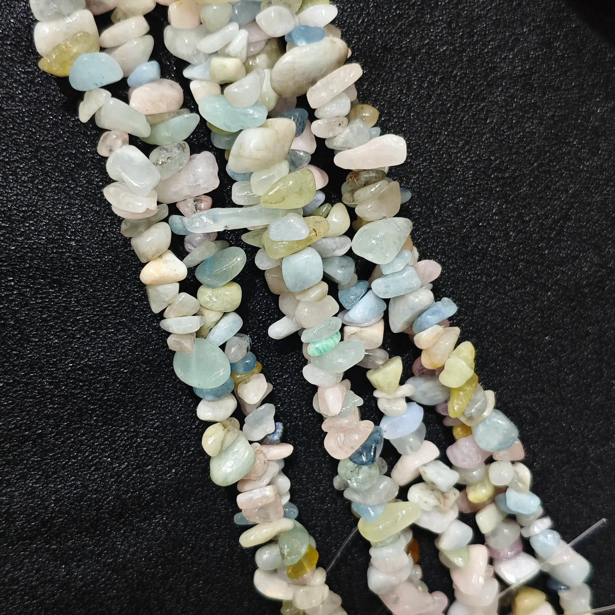 Close up of multi strands of natural multi-color morganite 5-10mm irregular pastel chips