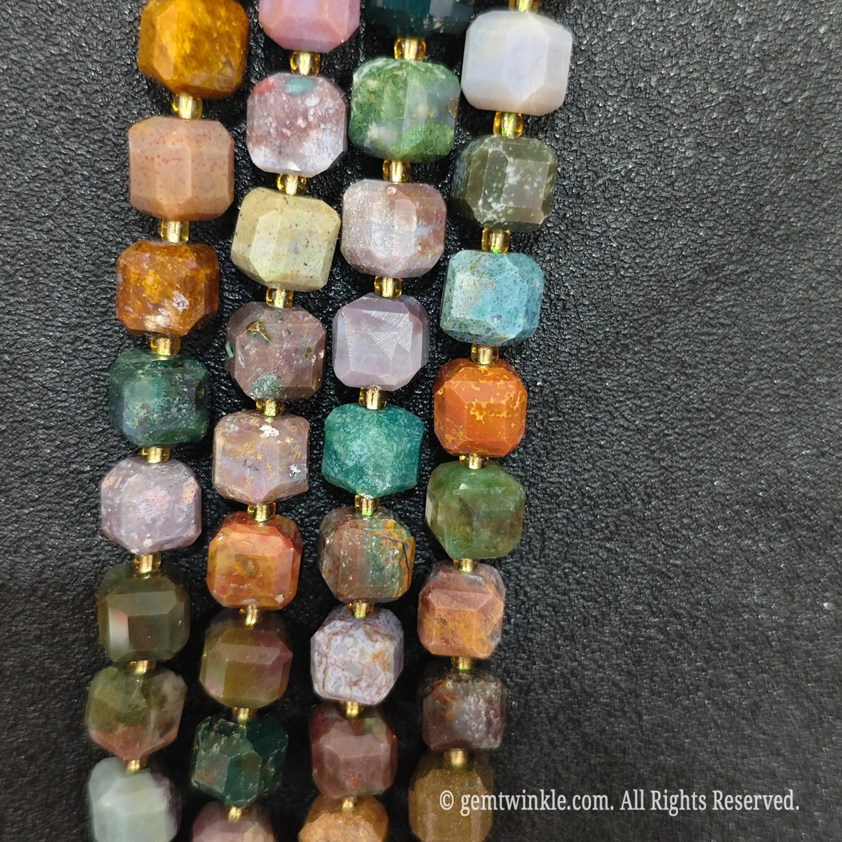 Fingers holding natural multi-color ocean jasper soft square gemstone block beads to show scale and proportion[cite: 8]