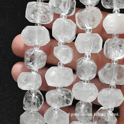 Close up of multiple strands of natural freeform milky white quartz pebble beads for handmade jewelry supplies