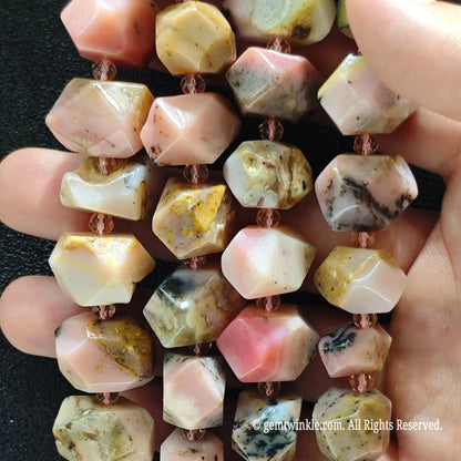 Close up of multiple strands of natural faceted pink andean opal pebble beads for handmade beading supplies