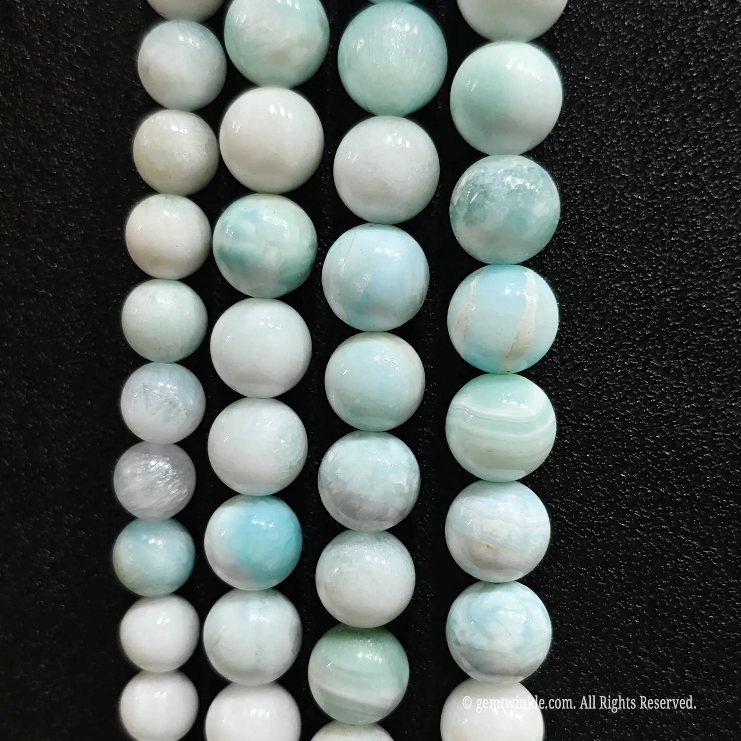 Loose hemimorphite gemstone beads with white and blue veining patterns