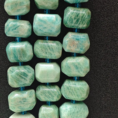 Strands of natural mint green amazonite freeform faceted beads with white grid veining displayed on dark background