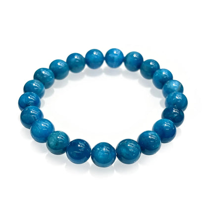 Natural blue apatite stretch bracelet with 9mm faceted round beads on elastic cord, displayed in circle on white background, no metal clasp