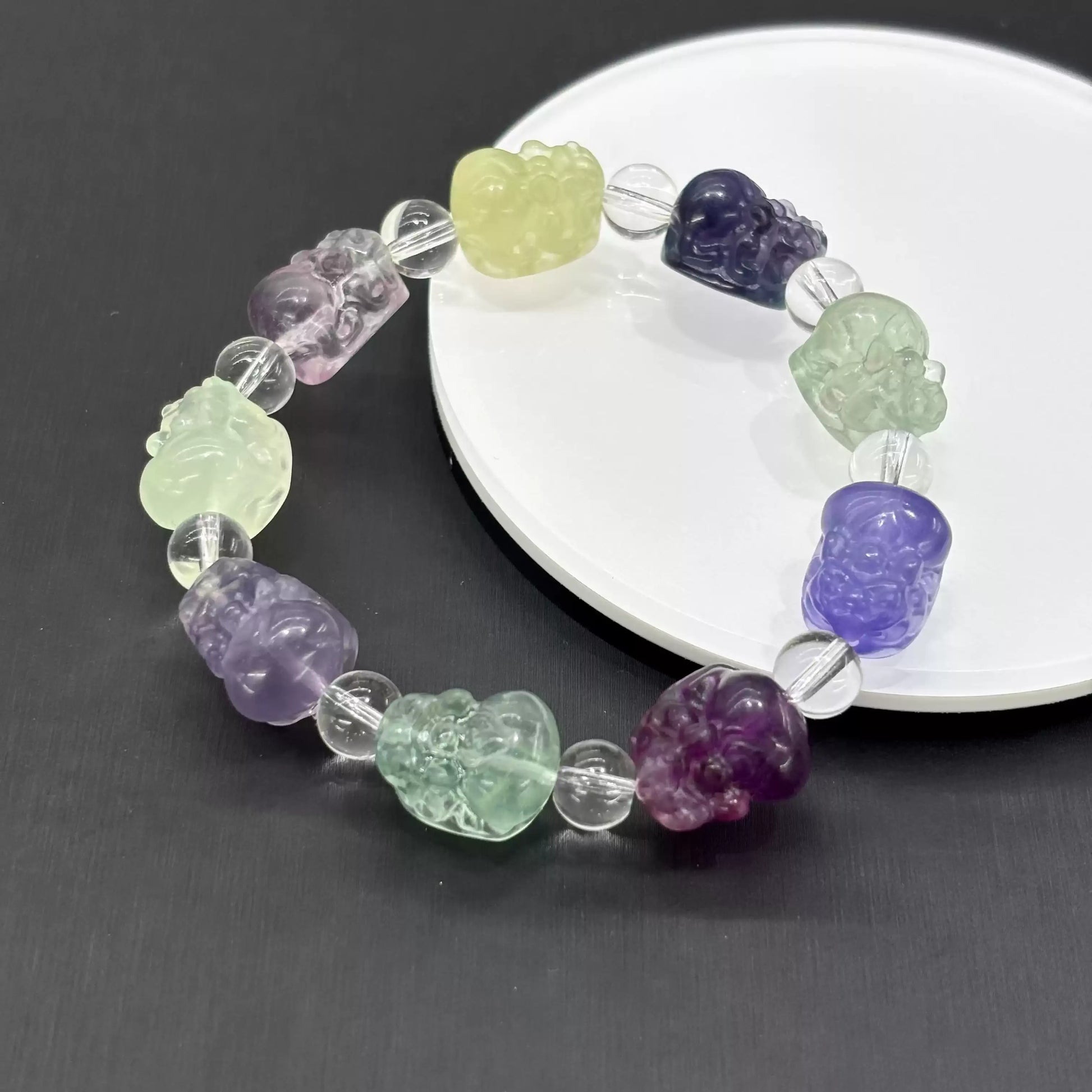 Each fluorite bead displays unique color zoning—purple, green, yellow, blue, and pink tones occur naturally in this mineral