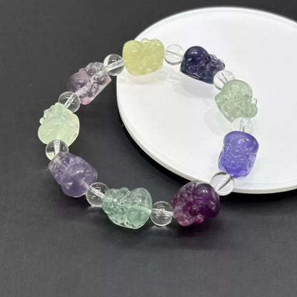 Each fluorite bead displays unique color zoning—purple, green, yellow, blue, and pink tones occur naturally in this mineral