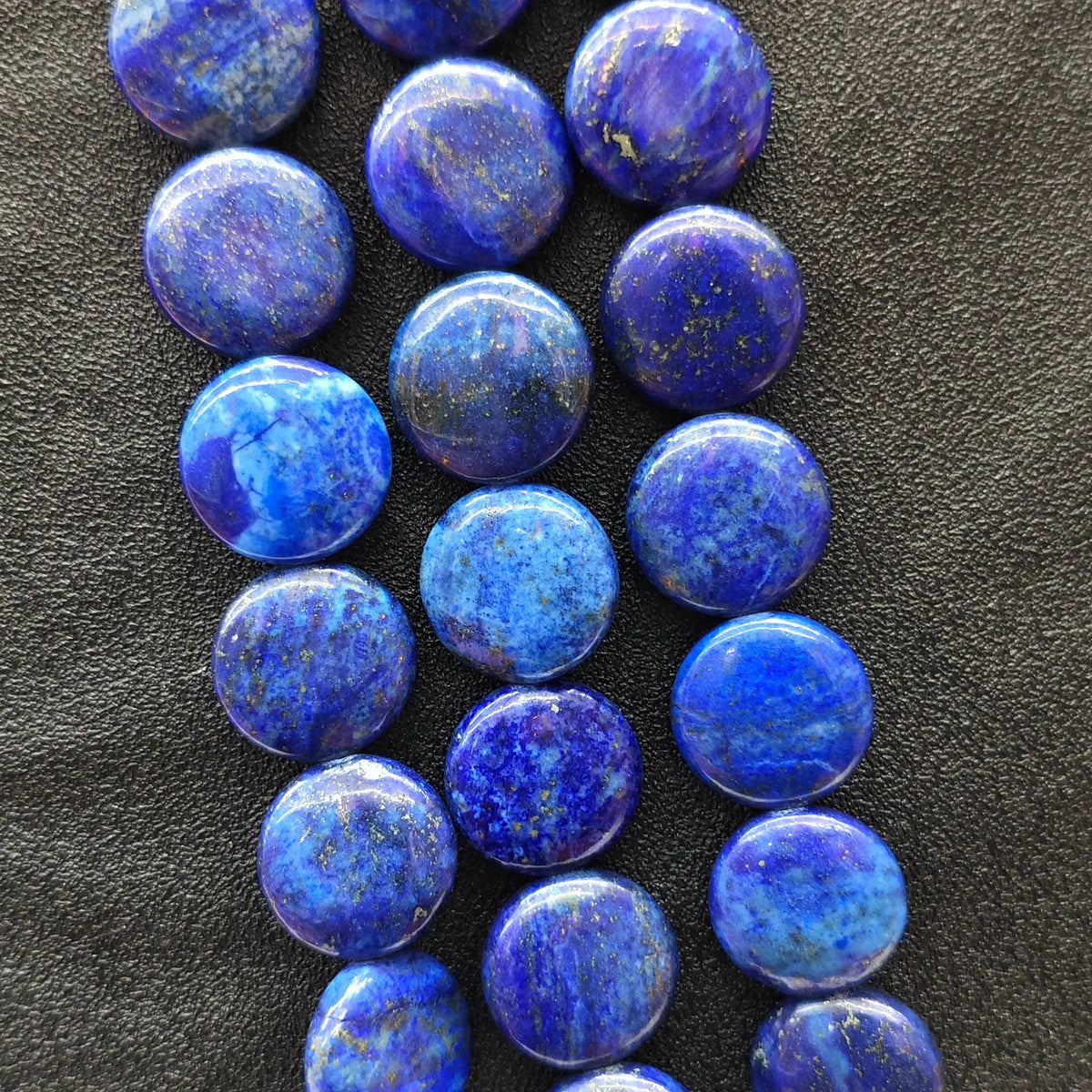 Strands of natural denim blue and white marbled lapis lazuli smooth flat round coin beads with golden pyrite specks for DIY jewelry making