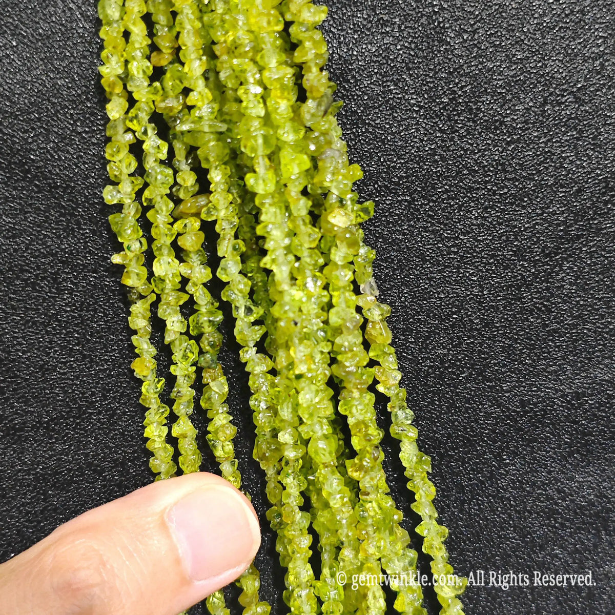 Detailed view of long 75cm natural peridot green chipped strand ready for jewelry making[cite: 6]