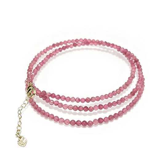 Natural pink tourmaline faceted round beads (3mm) in dual-layer wrap bracelet, gold-toned chain with heart charm on white background