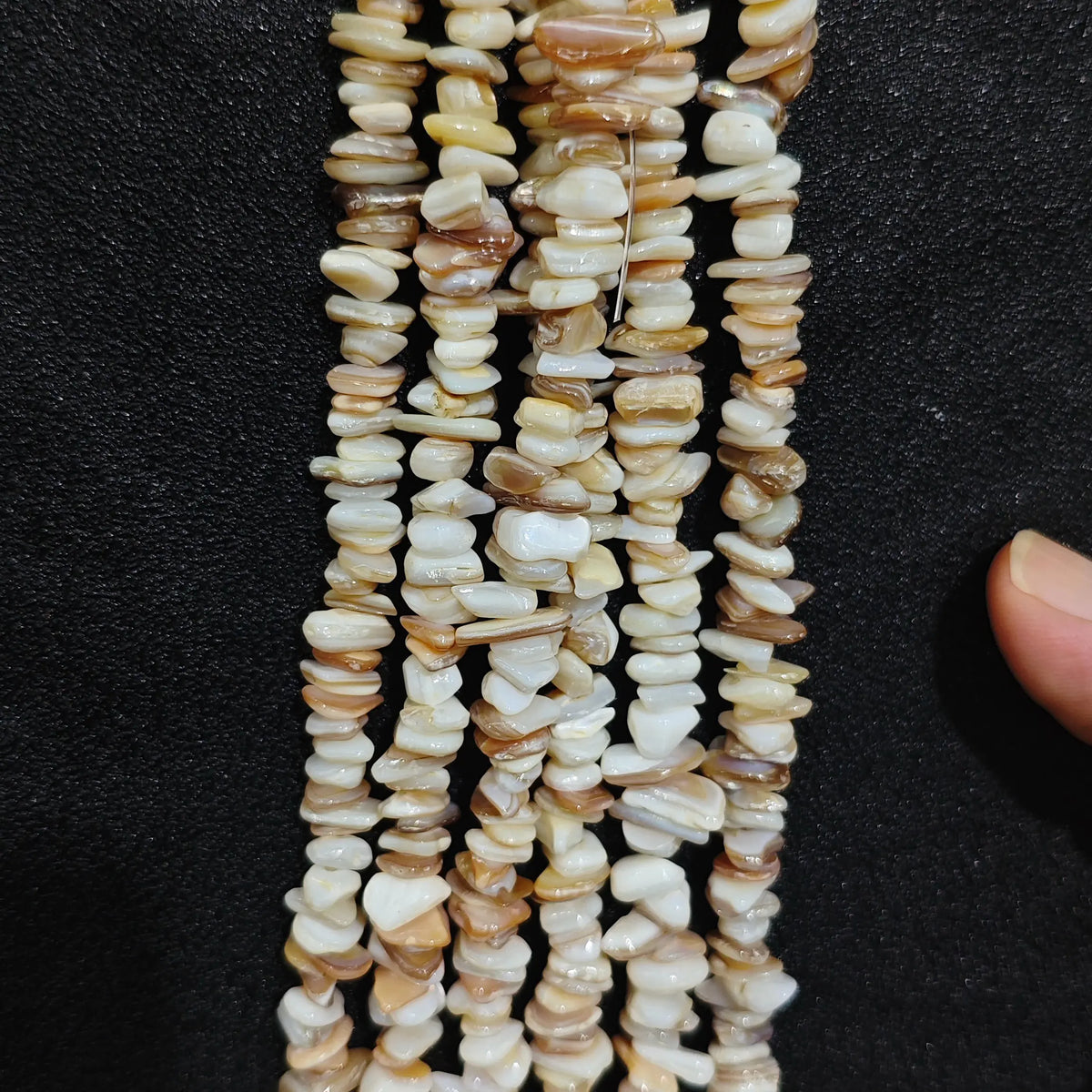Close up of multi strands of natural shell 5-10mm irregular white and beige pearlescent chips[cite: 8]