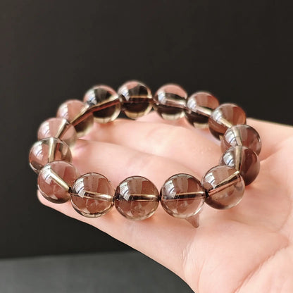 Natural smoky quartz round beads handchain on black background