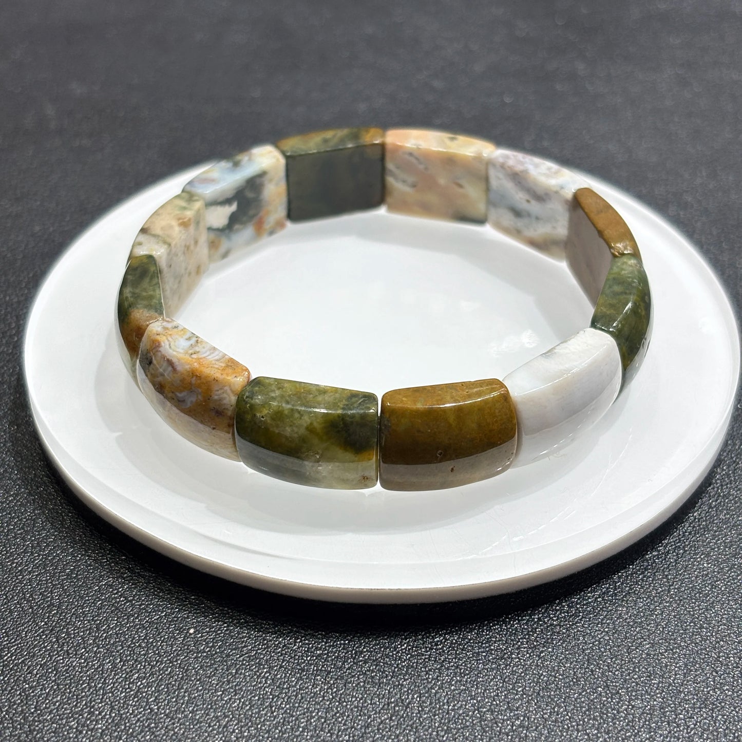 Overhead view: natural ocean jasper square beads in full circle; elastic cord hidden, ideal for mindful accessorizing