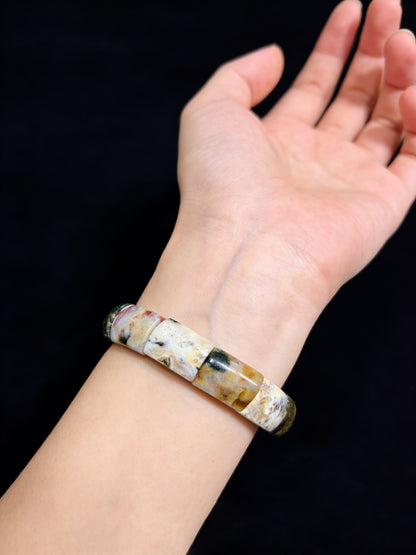 Woman wearing natural ocean jasper square bead bracelet; earthy tones, boho aesthetic, comfortable fit for everyday style