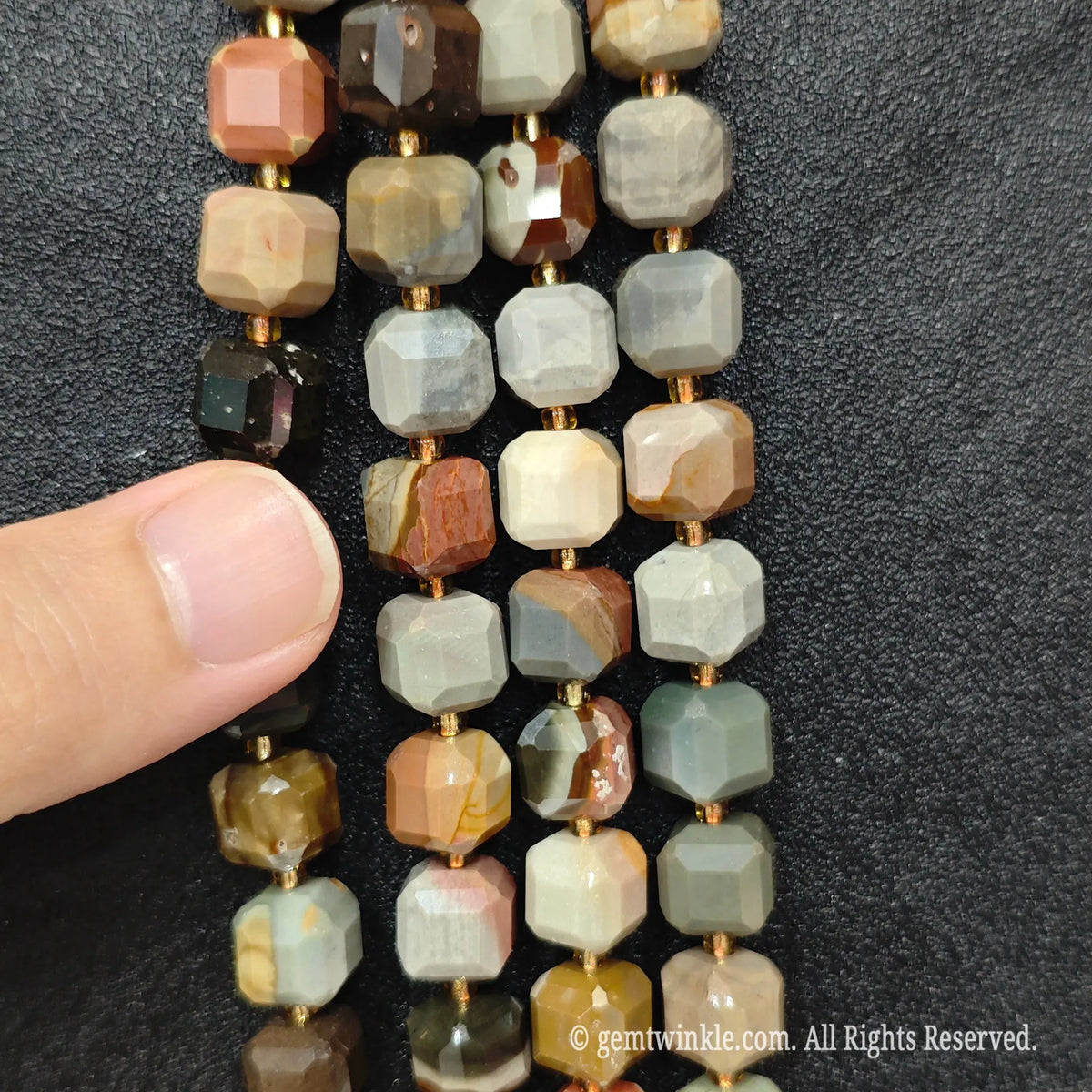 Fingers holding natural ocean jasper soft square gemstone block beads to show scale and proportion