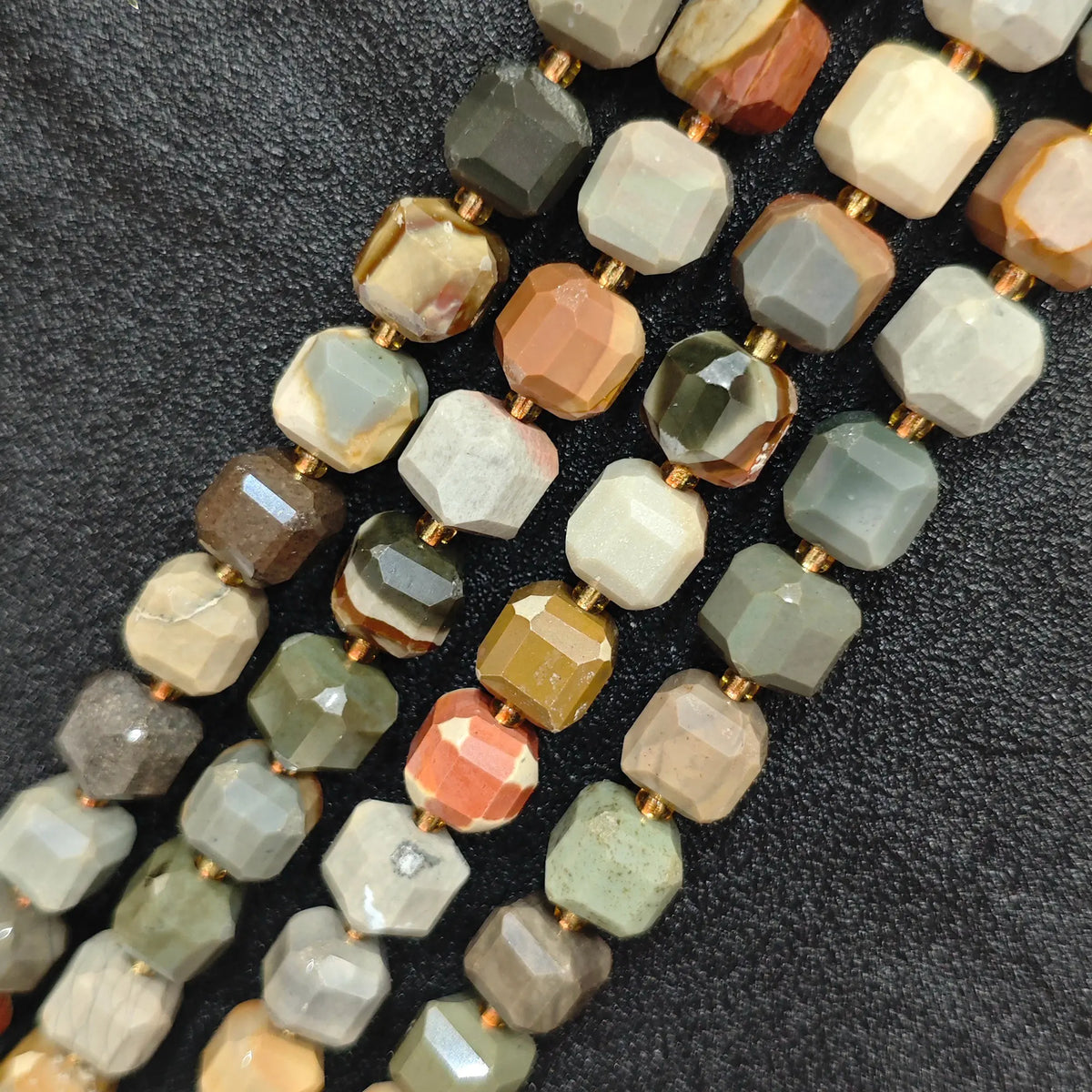 Close up of multi strands of natural ocean jasper soft-tumbled geometric cube beads showing overall strand layout