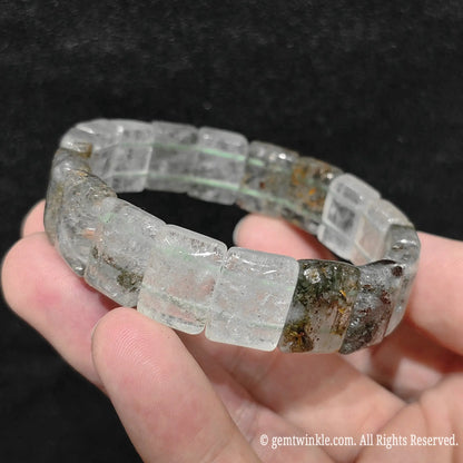 Side view of a natural opaque green phantom quartz smooth block tile stretch bracelet showing waxy polish and double row elastic construction