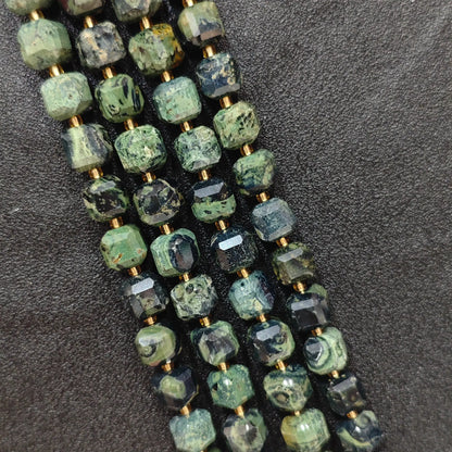 Close up of multi strands of natural peacock eye stone soft-tumbled geometric cube beads showing overall strand layout