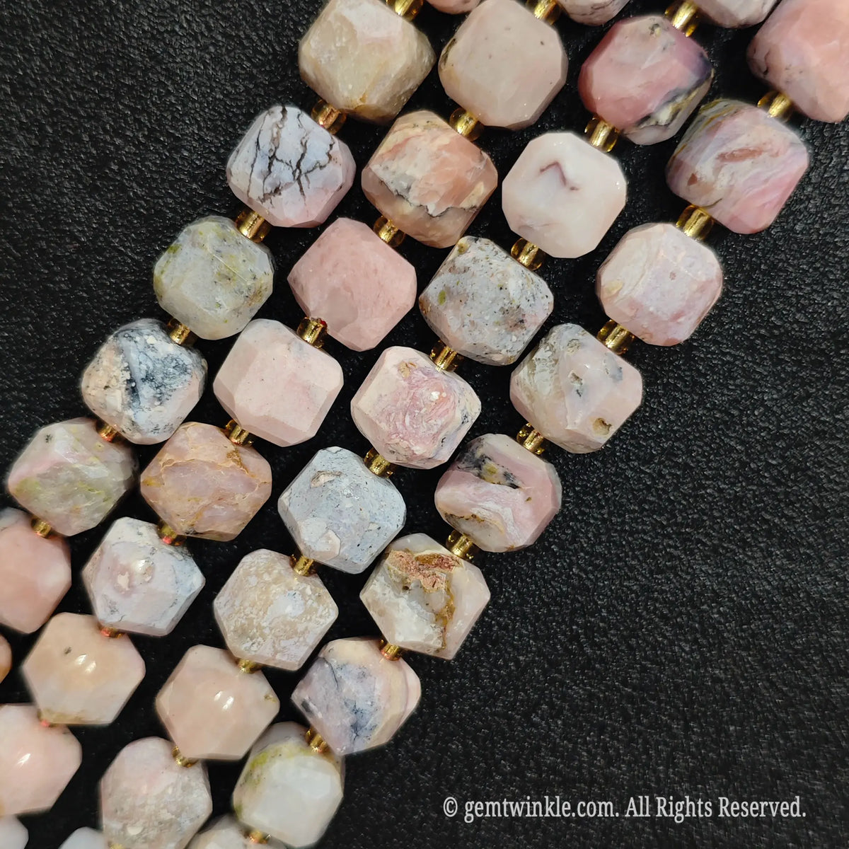 Multiple parallel strands of natural pink opal soft-tumbled cube beads viewed from distance[cite: 6]