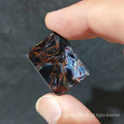 Detailed shot of custom jewelry petersite stone block demonstrating high gloss polish and flat back profile