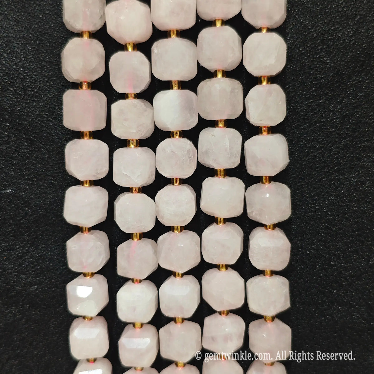 Detailed macro view of natural rose quartz 10mm geometric cube beads showcasing tender pink matrix and polished facets