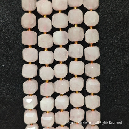 Detailed macro view of natural rose quartz 10mm geometric cube beads showcasing tender pink matrix and polished facets