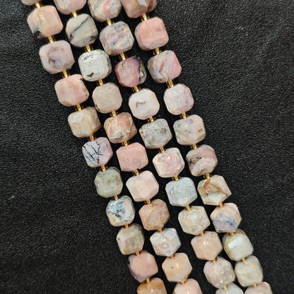 Close up of multi strands of natural pink opal soft-tumbled geometric cube beads showing overall strand layout[cite: 6]