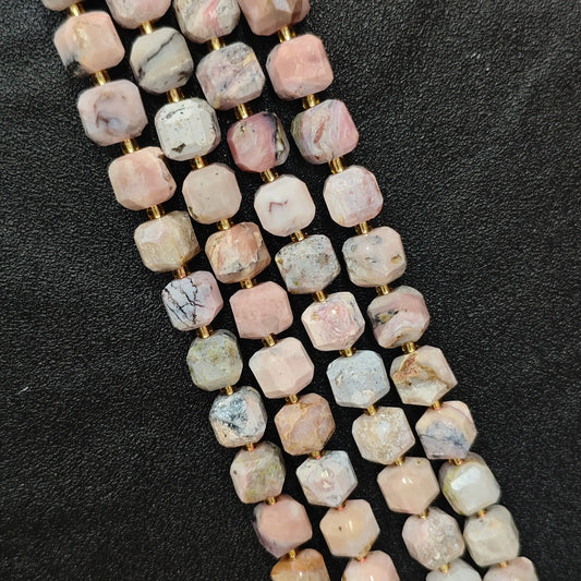 Close up of multi strands of natural pink opal soft-tumbled geometric cube beads showing overall strand layout[cite: 6]