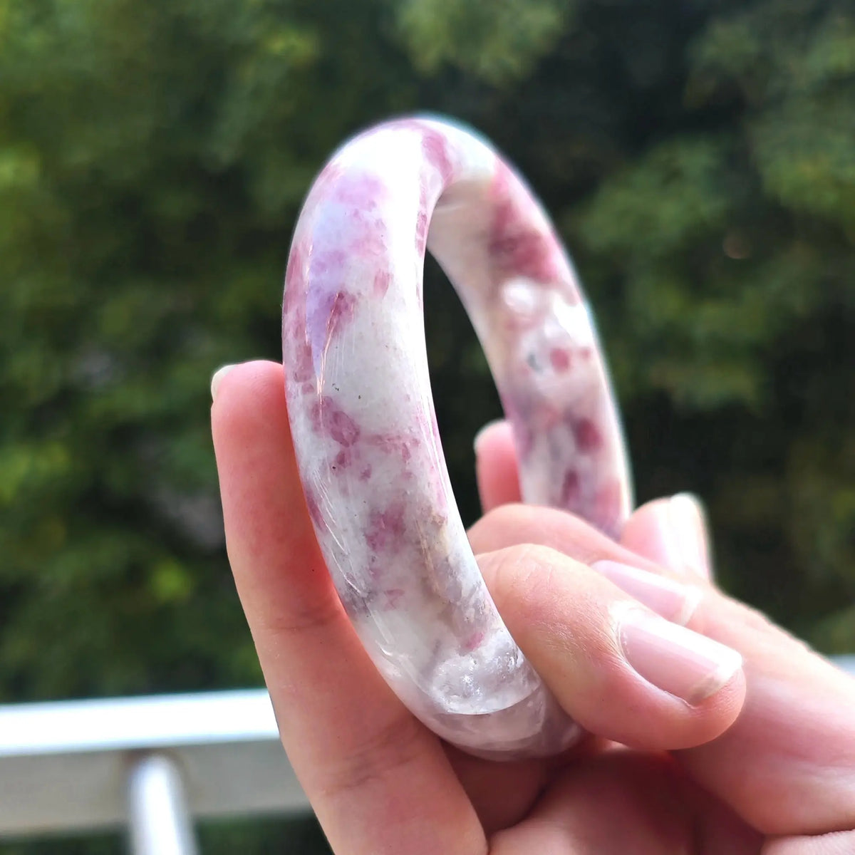 Detailed perspective of natural plum blossom tourmaline bangle ideal for retail jewelry stores and heart chakra healing gifts