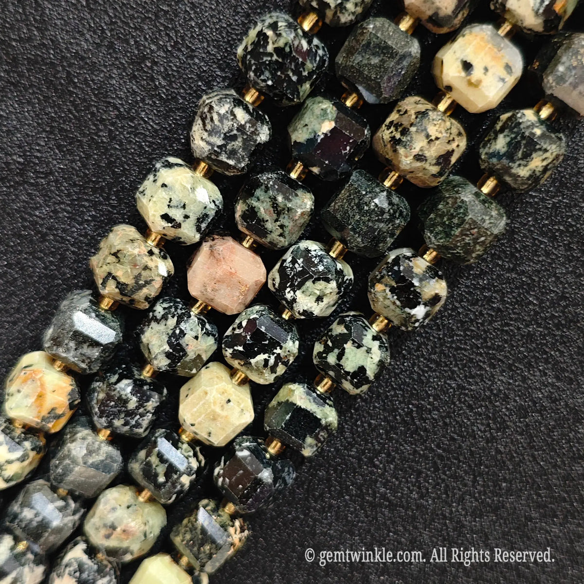 Multiple parallel strands of natural fancy jasper soft-tumbled cube beads viewed from distance showing varied earth tones