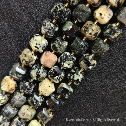 Multiple parallel strands of natural fancy jasper soft-tumbled cube beads viewed from distance showing varied earth tones