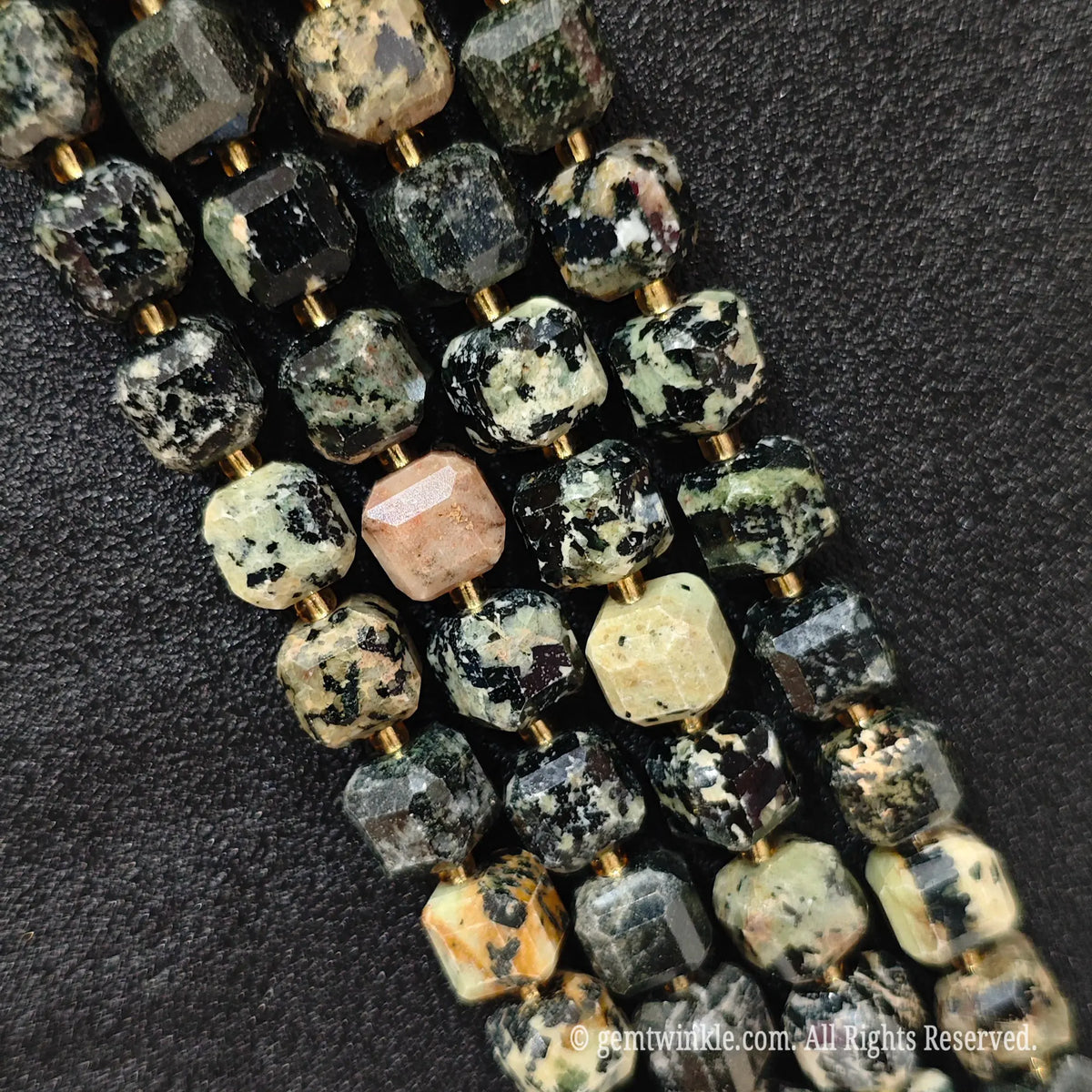 Detailed macro view of natural fancy jasper geometric cube beads showcasing speckled matrix and rich color variations