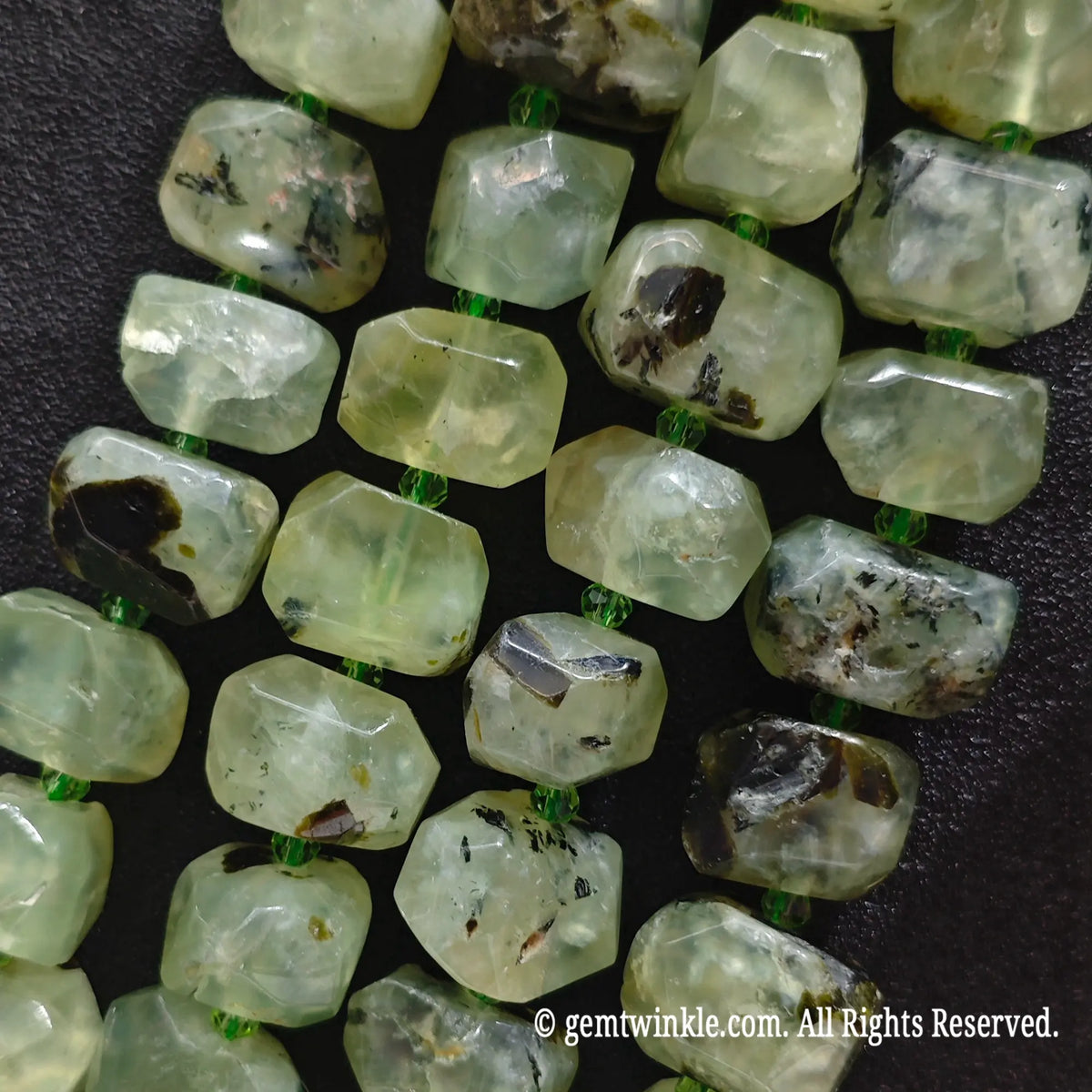 Multiple strands of natural green prehnite freeform faceted beads aligned showing unique shapes and bead variations