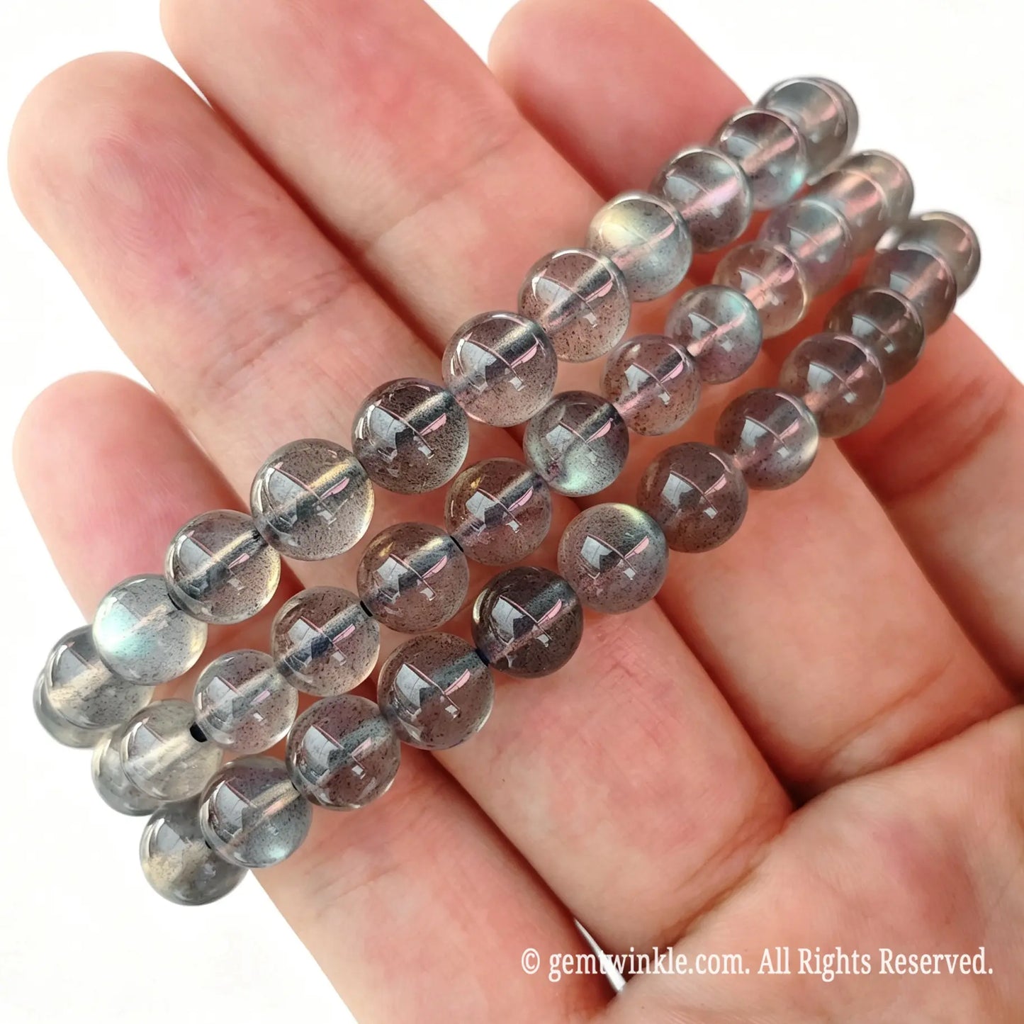 Hand preview of a single-strand grey moonstone bead bracelet on durable stretch cord