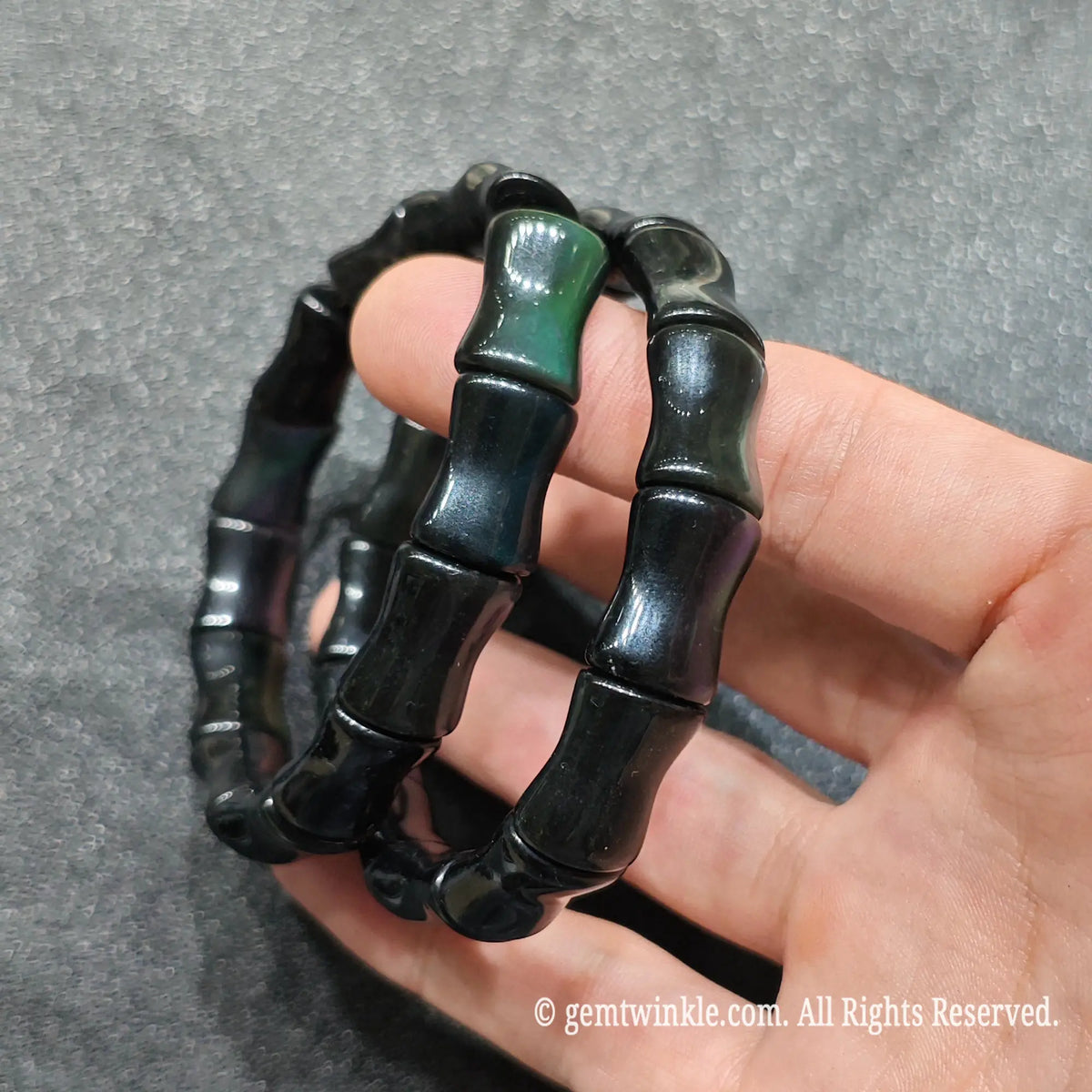 Two rainbow obsidian bamboo shape bracelets showcasing good fortune symbol and dark glossy texture[cite: 1]