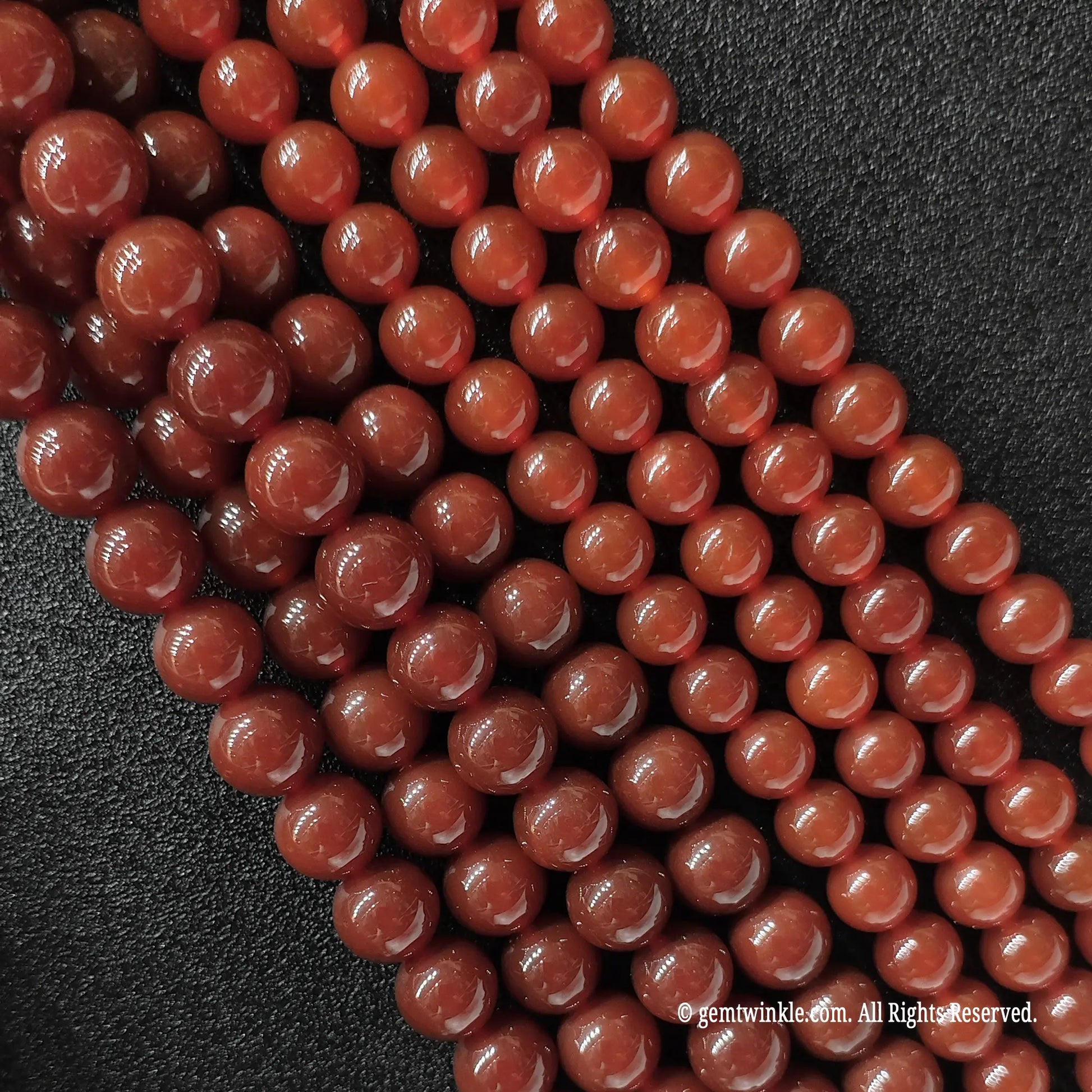 Red Agate round beads side angle view