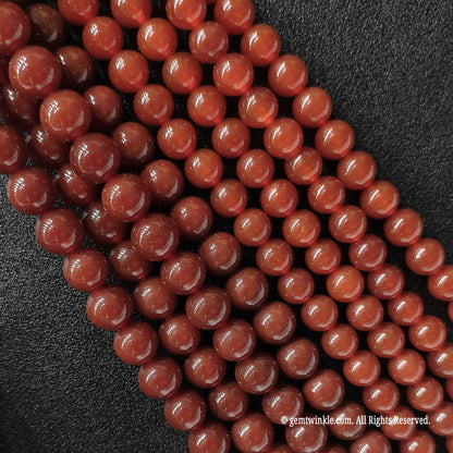Red Agate round beads side angle view