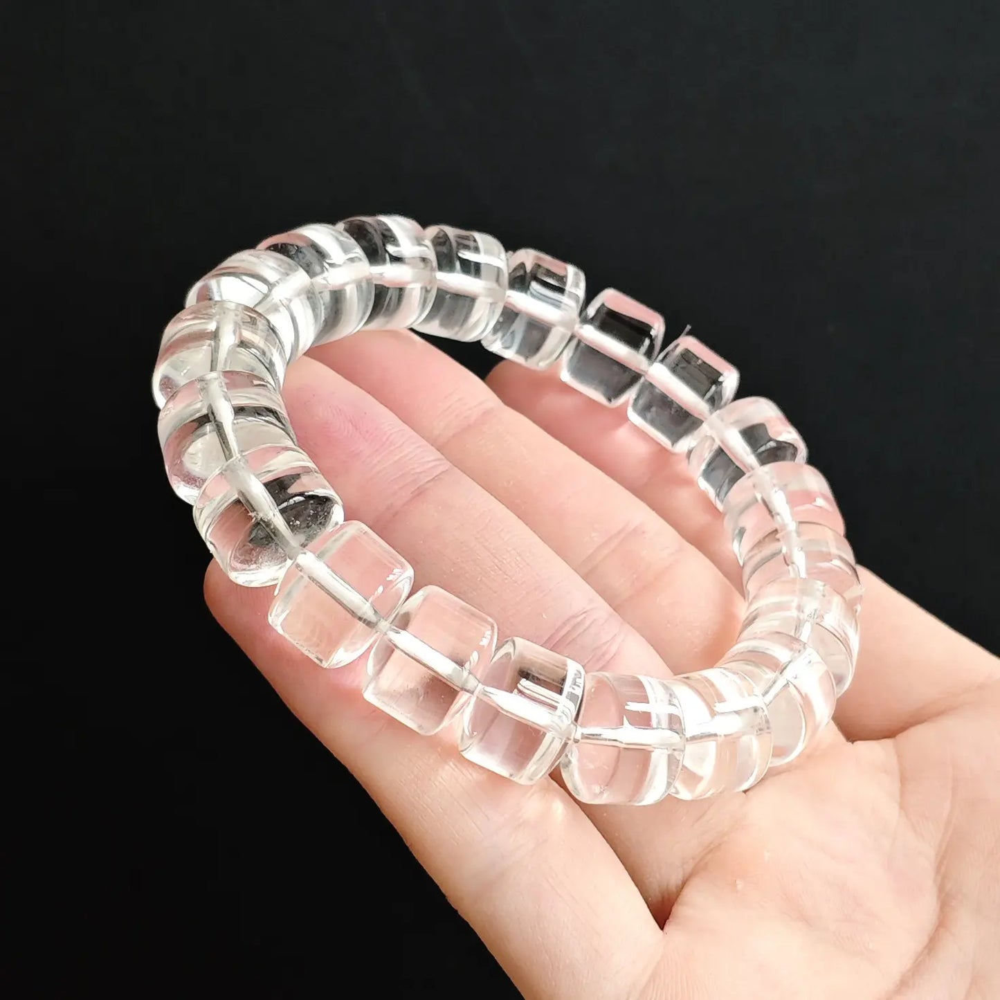Unisex clear quartz rondelle bead handchain held flat—showing consistent thickness, clean symmetry, and transparent purity