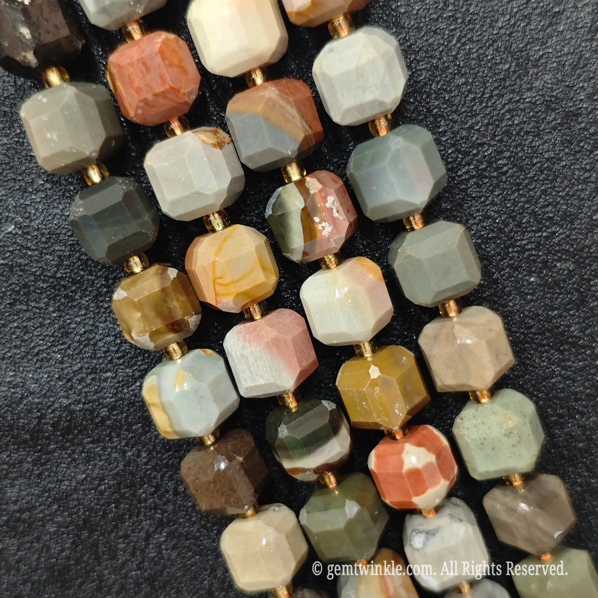 Detailed macro view of natural ocean jasper geometric cube beads showcasing earthy color mixes and natural matrix