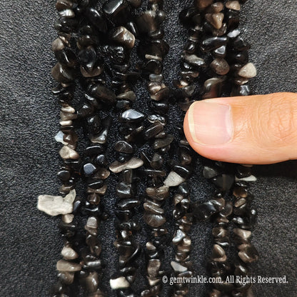 Silver Sheen Obsidian has a Mohs hardness of 5 to 5.5 and is a natural form of volcanic glass. To protect its polished surface and prevent scratches, avoid hard impacts, harsh chemical detergents, or ultrasonic jewelry cleaners. Clean gently with lukewarm soapy water and a soft cloth, and store separately in a soft cloth pouch.