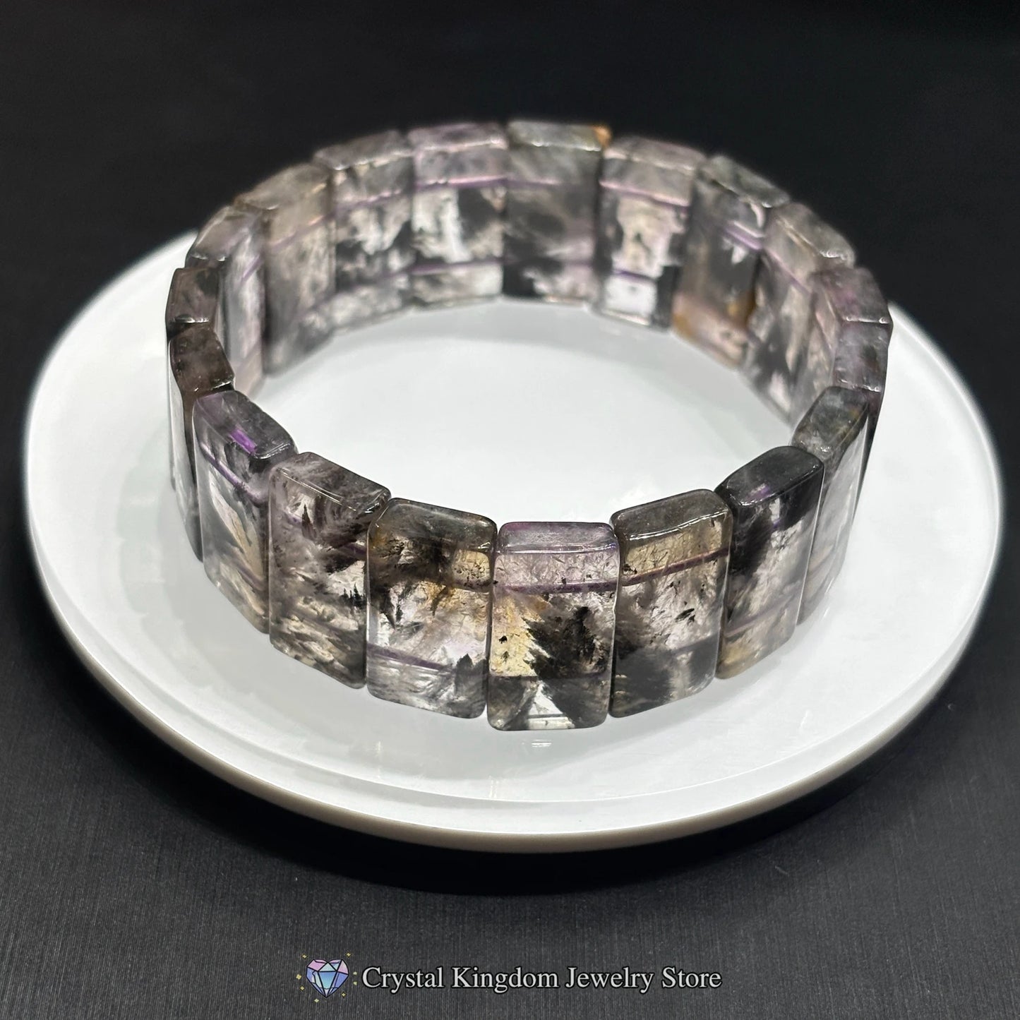 Close-up of single black dream phantom quartz rectangular slab bead bracelet, showcasing natural dendritic patterns and smooth finish