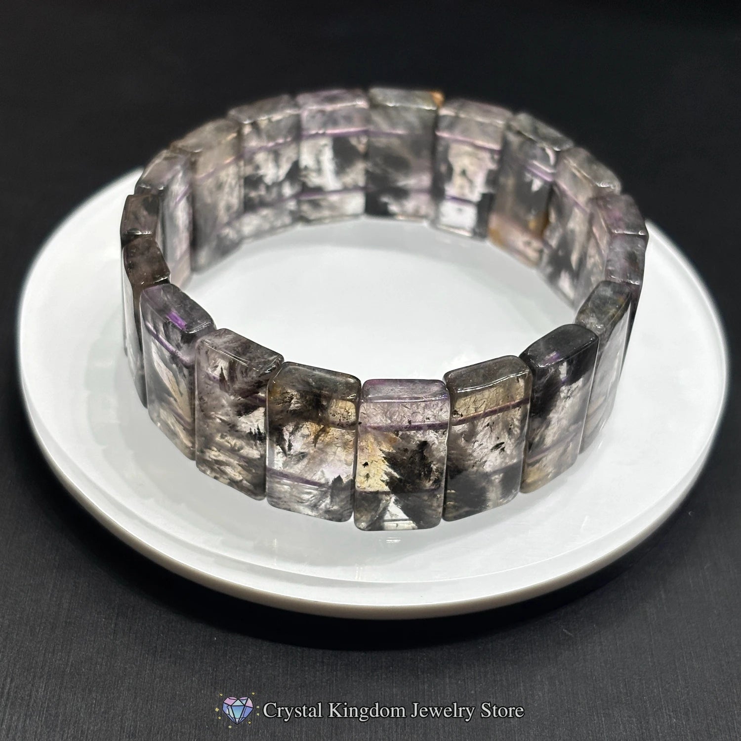 Close-up of single black dream phantom quartz rectangular slab bead bracelet, showcasing natural dendritic patterns and smooth finish