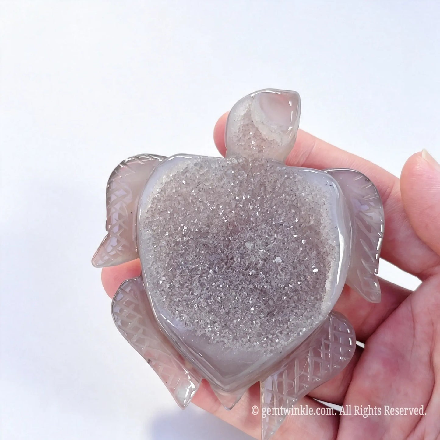 Agate sea turtle statue showing broad raw crystal druzy cluster shell surface held in hand