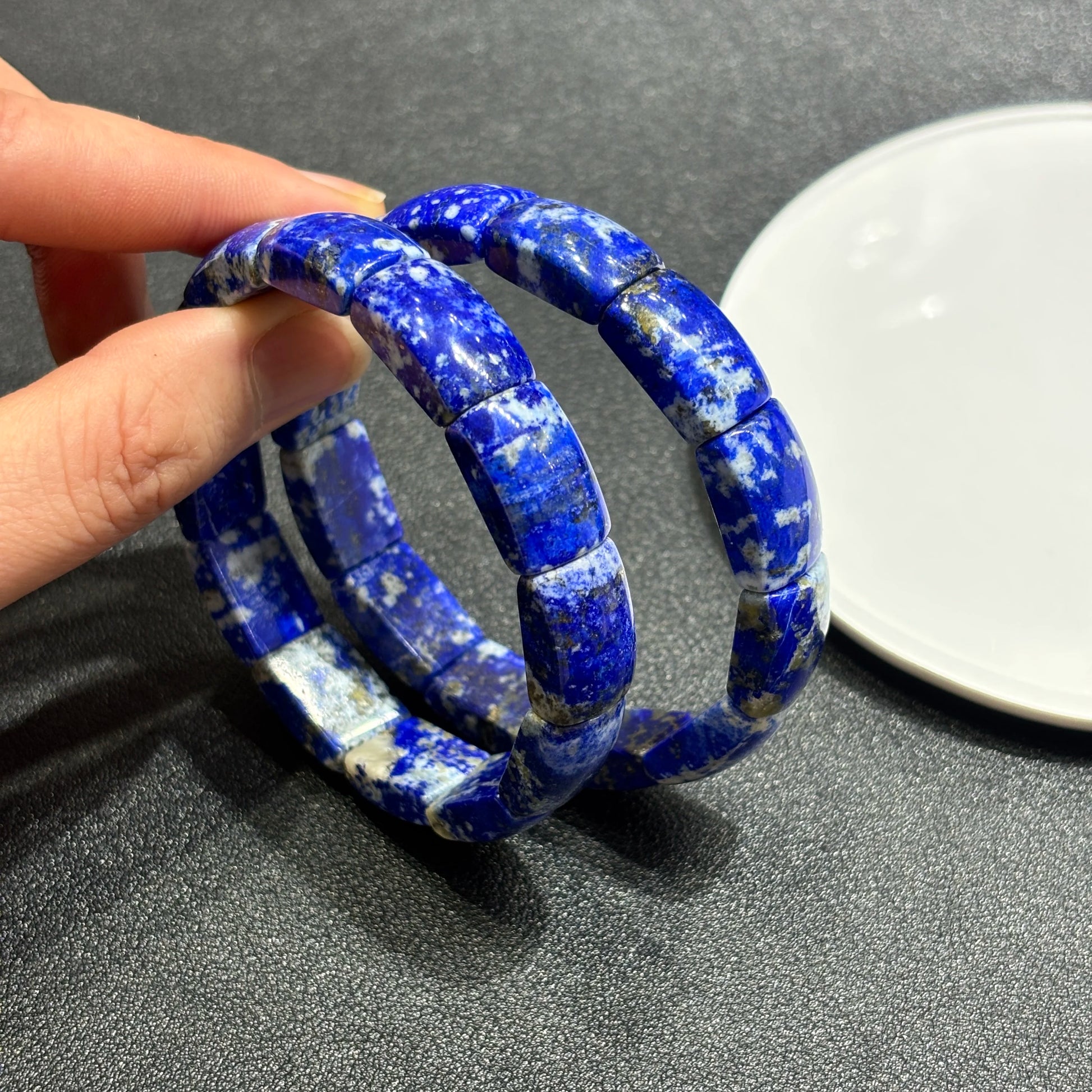 Two natural lapis lazuli square bead bracelets held together; shows rich blue color, white matrix, and stackable boho styling